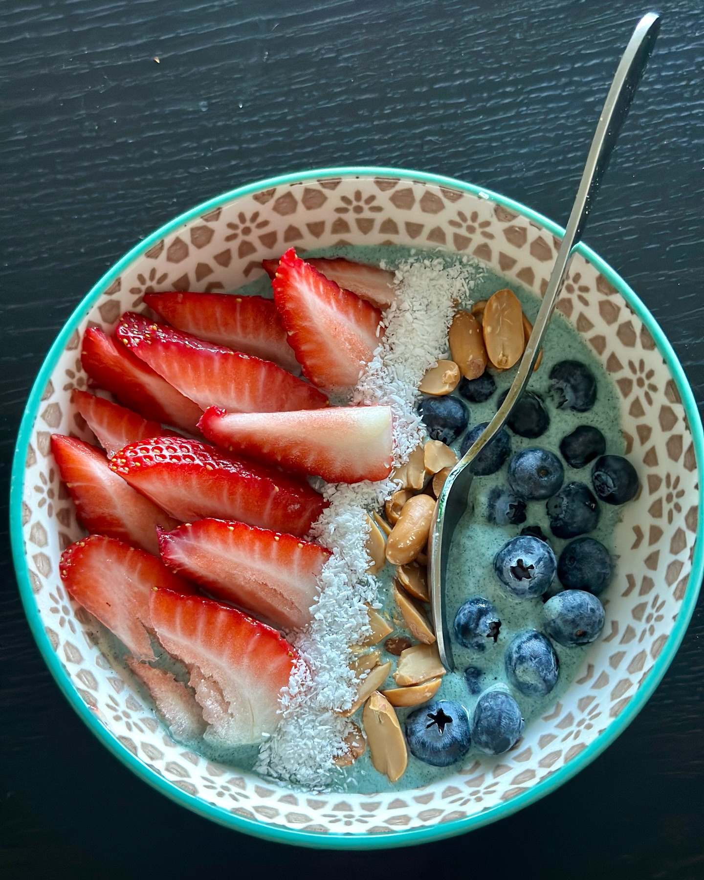 Berry, fruit, nut, and coconut breakfast bowl