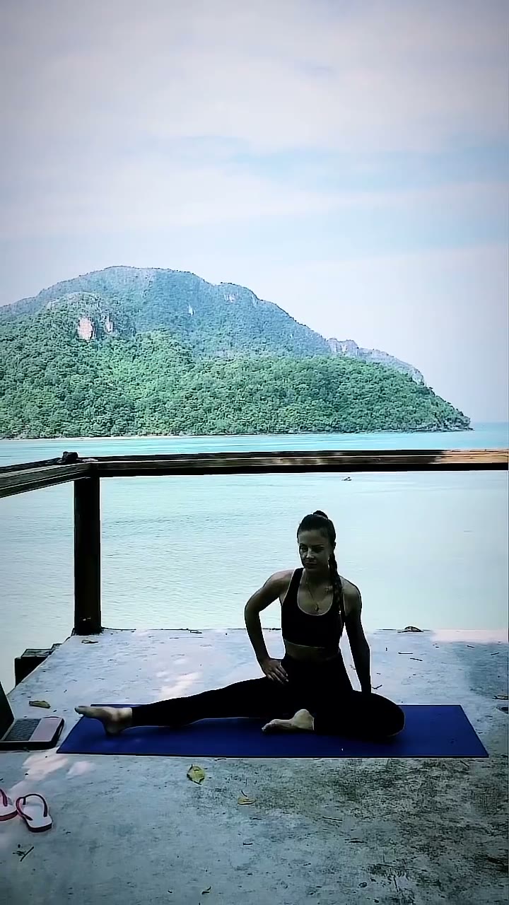 Inna preparing for a mobility exercise on a mat